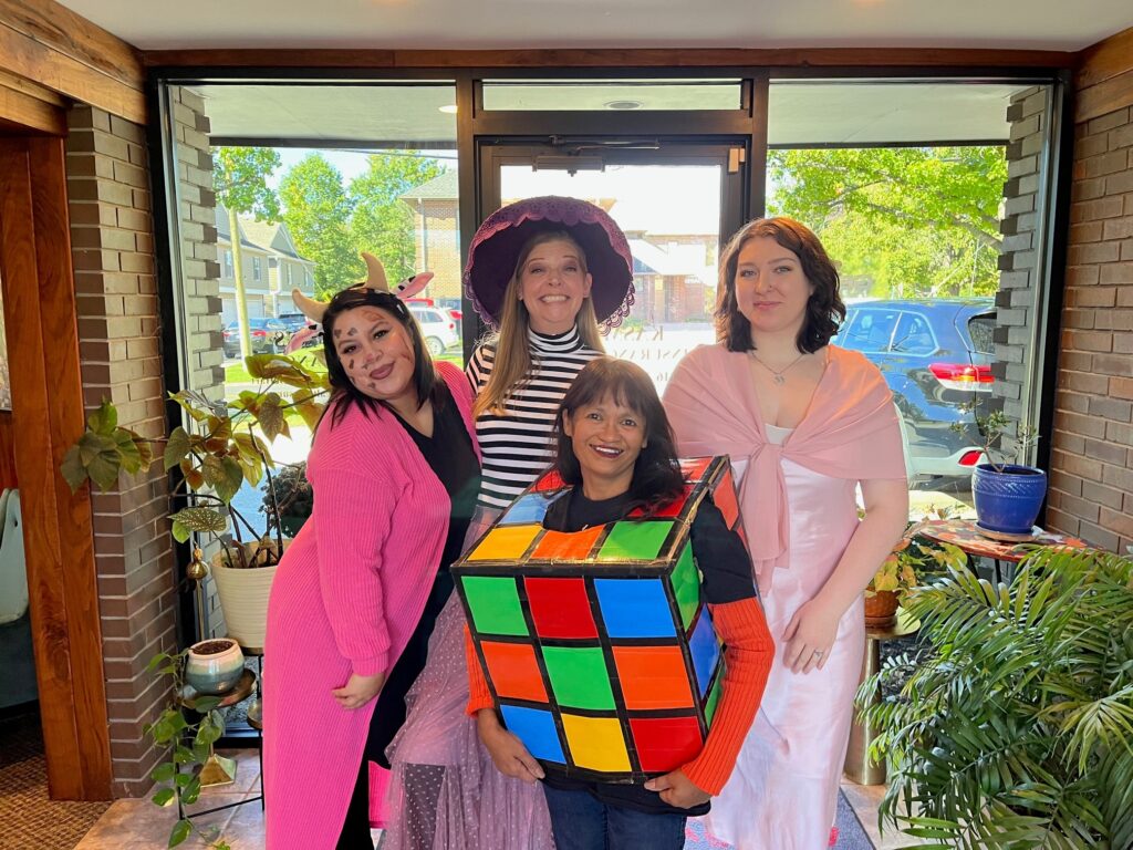 This is a picture of the agency staff dressed in Halloween costumes. They are each described in the post text.